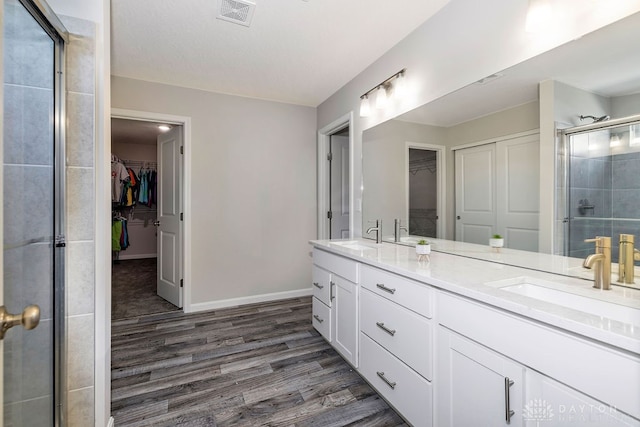 bathroom with vanity, hardwood / wood-style flooring, and an enclosed shower