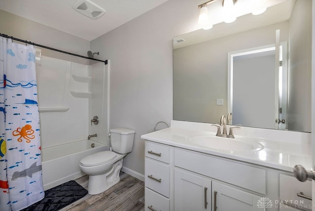 full bathroom featuring shower / tub combo with curtain, vanity, hardwood / wood-style flooring, and toilet