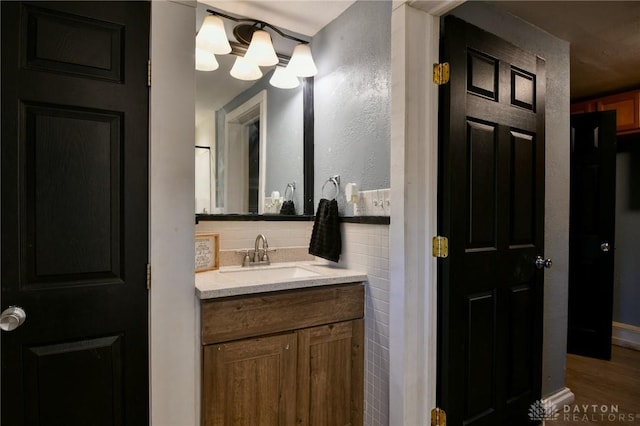 bathroom featuring tasteful backsplash, vanity, and hardwood / wood-style floors