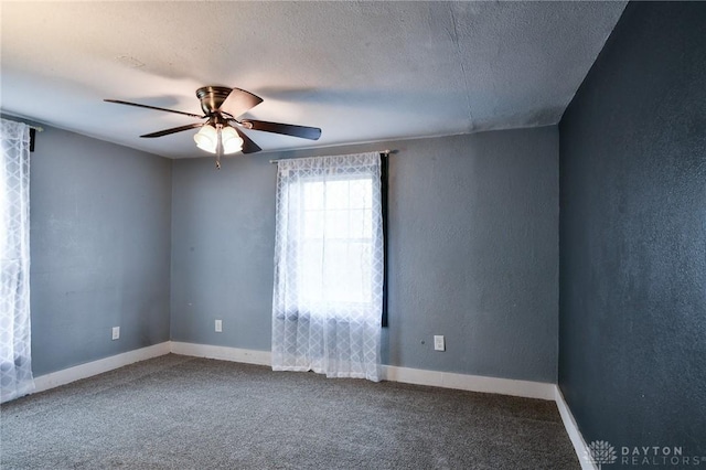 unfurnished room featuring ceiling fan, carpet flooring, and a textured ceiling