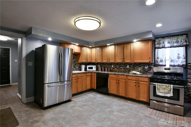 kitchen with stainless steel appliances and backsplash