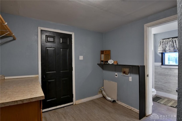 laundry area featuring electric dryer hookup, washer hookup, and wood-type flooring