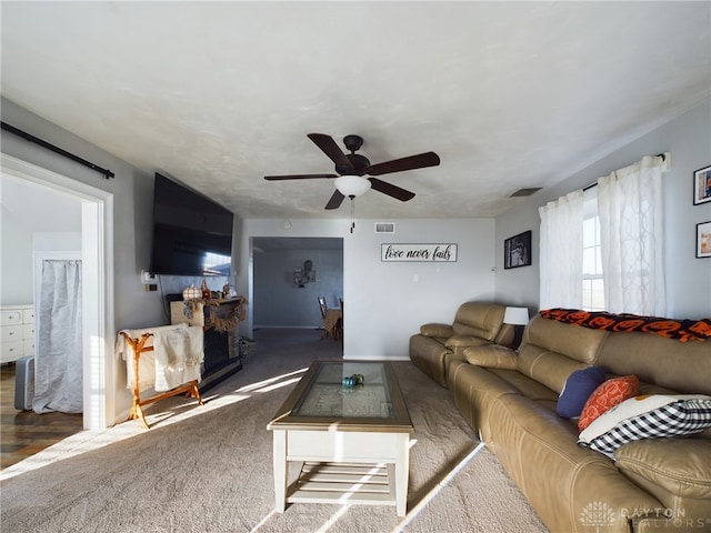 living room featuring dark hardwood / wood-style flooring and ceiling fan