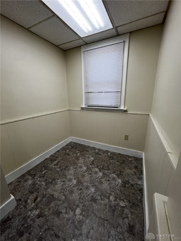 unfurnished room with a drop ceiling