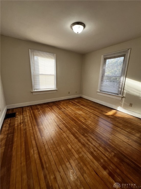 spare room with hardwood / wood-style flooring