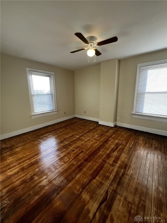 unfurnished room featuring ceiling fan and dark hardwood / wood-style floors