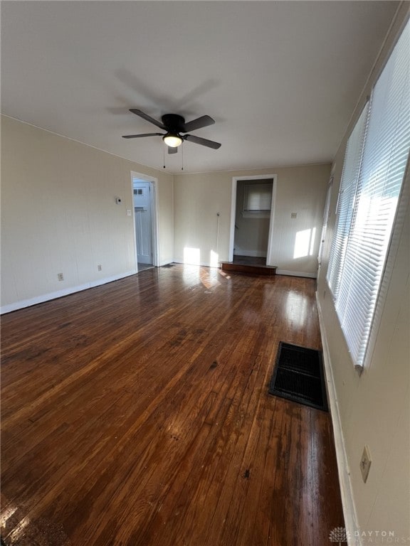 spare room featuring ceiling fan and dark hardwood / wood-style flooring