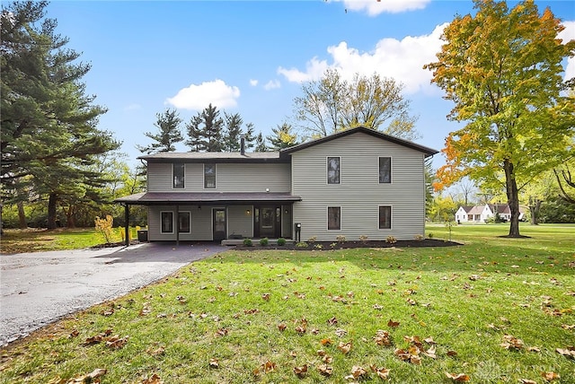 view of property with a carport and a front lawn