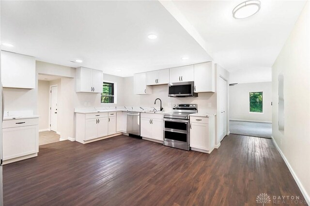 kitchen featuring sink, white cabinets, stainless steel appliances, and dark hardwood / wood-style floors