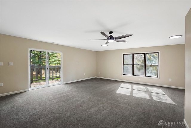 carpeted empty room featuring a healthy amount of sunlight and ceiling fan