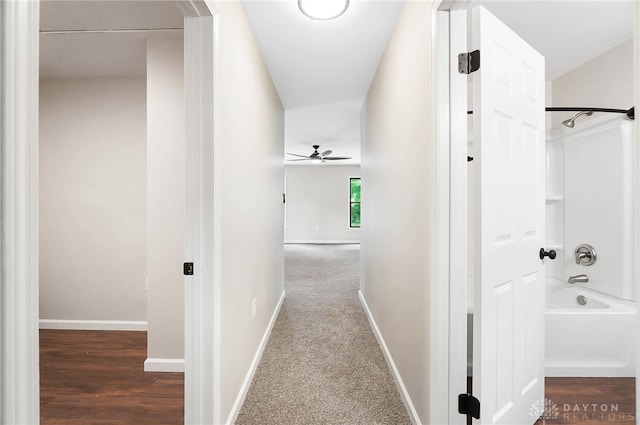 corridor with wood-type flooring