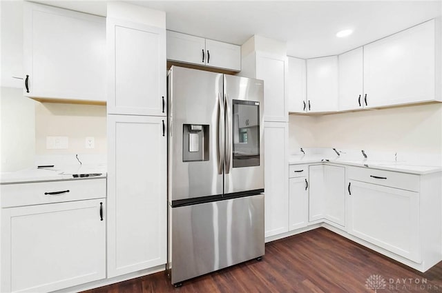 kitchen with stainless steel fridge with ice dispenser, dark wood-style flooring, light countertops, white cabinetry, and recessed lighting