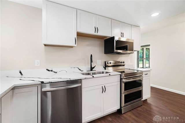 kitchen featuring sink, dark wood-type flooring, white cabinets, and stainless steel appliances