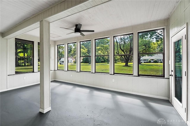 unfurnished sunroom featuring ceiling fan