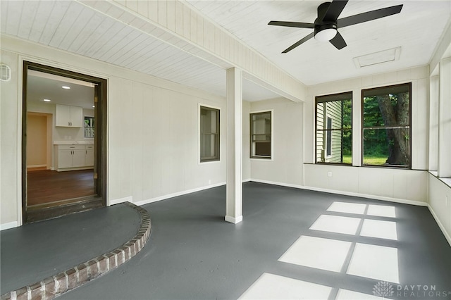 unfurnished sunroom featuring ceiling fan and wooden ceiling