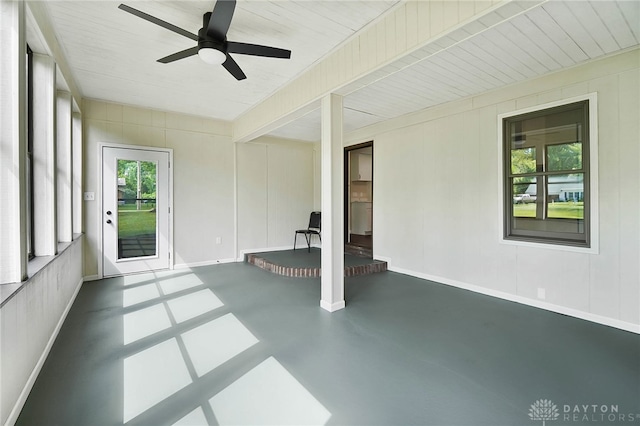 unfurnished sunroom with a wealth of natural light and ceiling fan