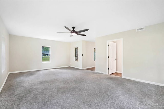 carpeted empty room featuring ceiling fan