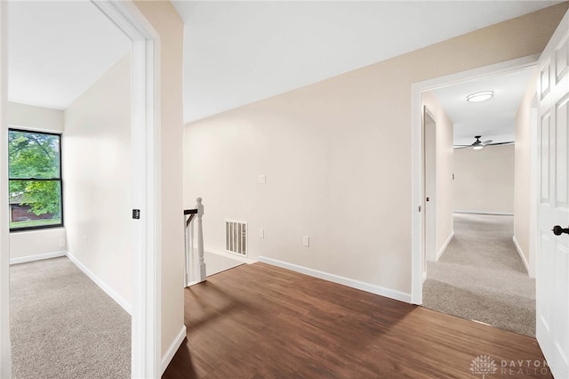 corridor featuring vaulted ceiling and hardwood / wood-style floors