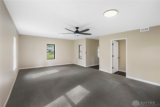 unfurnished room featuring ceiling fan and dark carpet