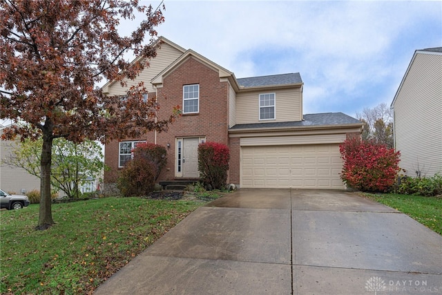 view of front property featuring a garage and a front yard