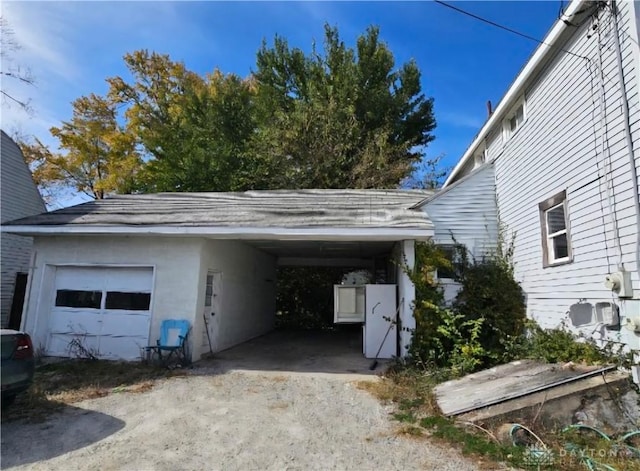 view of parking with a garage and a carport