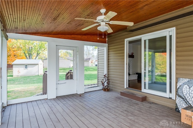 unfurnished sunroom with wood ceiling, ceiling fan, and vaulted ceiling