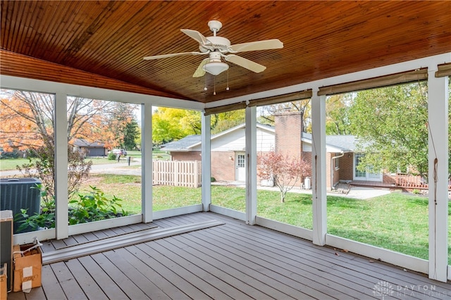 unfurnished sunroom with ceiling fan, vaulted ceiling, and wood ceiling