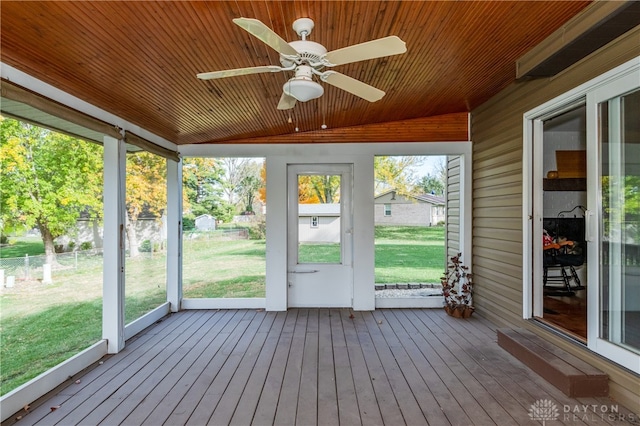 unfurnished sunroom featuring vaulted ceiling, wooden ceiling, and ceiling fan