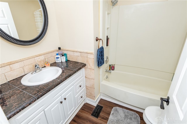 full bathroom featuring vanity, toilet, wood-type flooring, and tub / shower combination