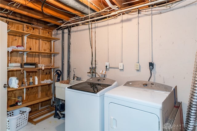 clothes washing area with sink and washer and clothes dryer