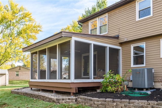 view of property exterior with a sunroom and cooling unit