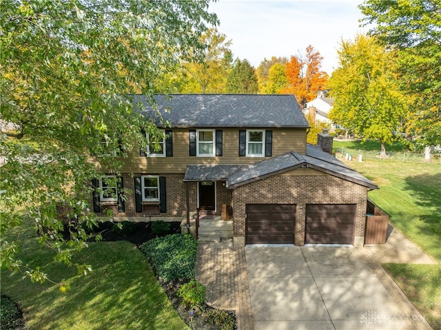 view of front of house featuring a front yard and a garage