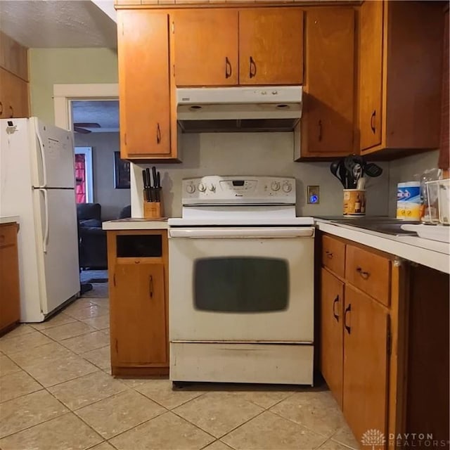 kitchen with white appliances and light tile patterned floors