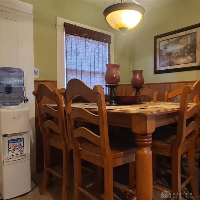 dining area featuring wood walls