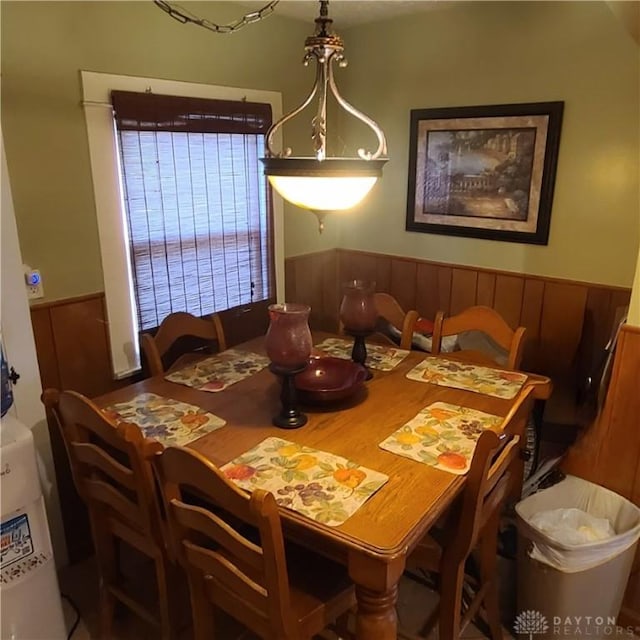 dining room featuring wood walls