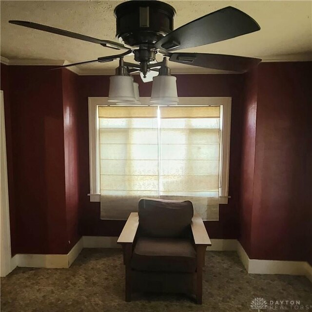 sitting room featuring ceiling fan and crown molding