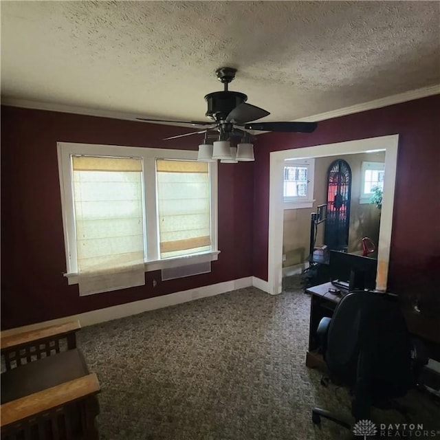 office space featuring carpet, a textured ceiling, ceiling fan, and crown molding