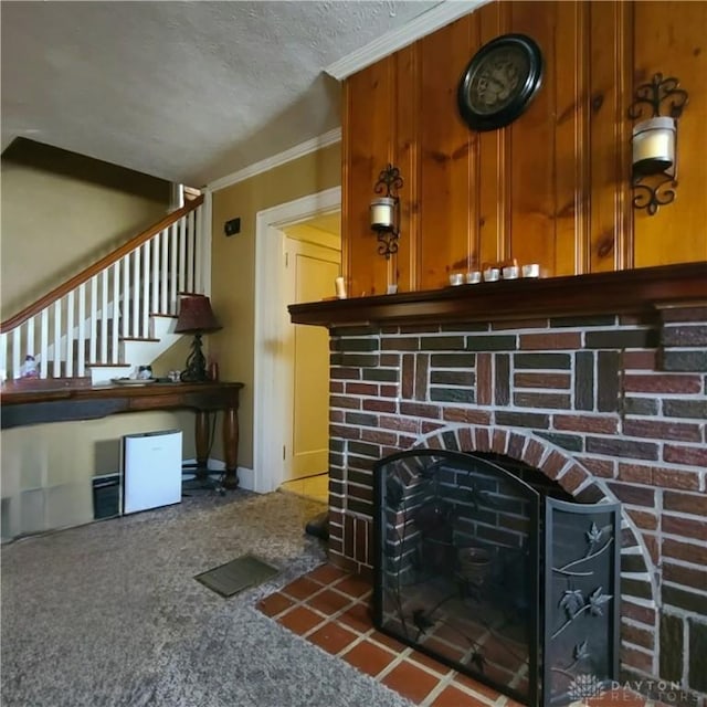 details with carpet flooring, ornamental molding, a textured ceiling, and a brick fireplace