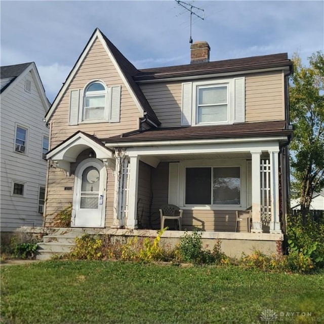 view of front of house featuring a front yard and covered porch