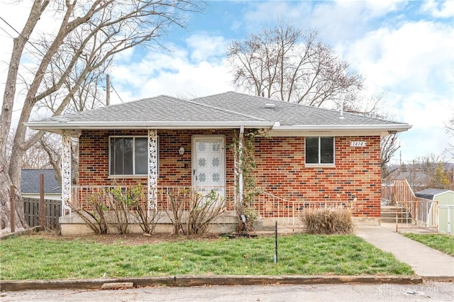 bungalow-style home with a front yard