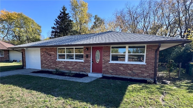 single story home featuring a front lawn and a garage