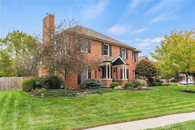 colonial home featuring a front lawn