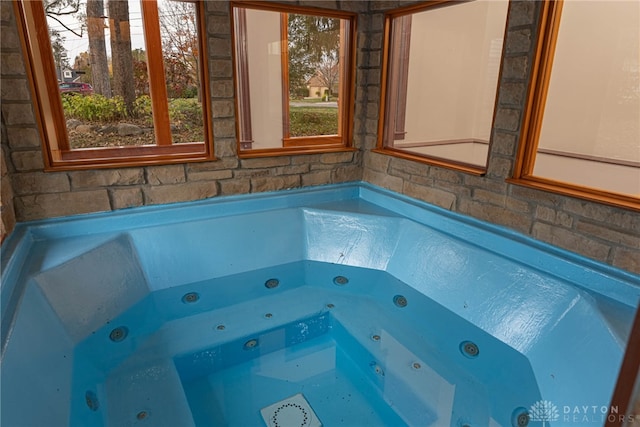 view of pool featuring an indoor hot tub