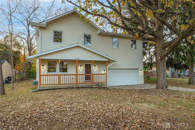 front of property with a garage, a porch, and central air condition unit