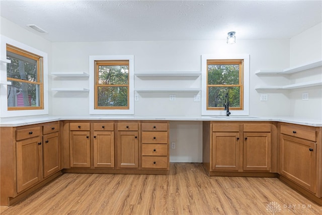 kitchen with a textured ceiling, plenty of natural light, and sink