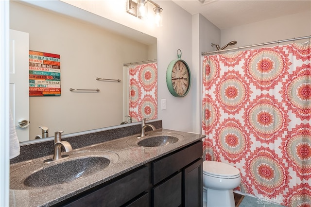 bathroom featuring vanity, toilet, and a shower with shower curtain