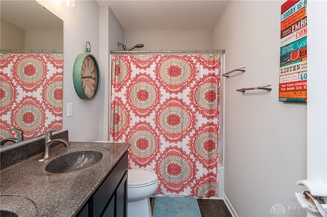 full bathroom with vanity, shower / bath combo with shower curtain, wood-type flooring, and toilet