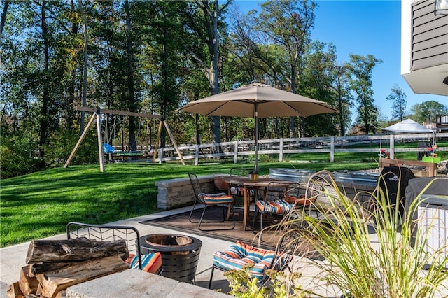 view of patio featuring an outdoor fire pit and a playground