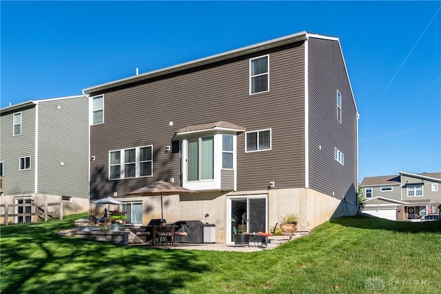 back of property with a yard and a patio