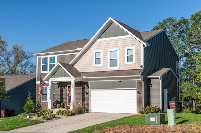 craftsman house with a front lawn and a garage